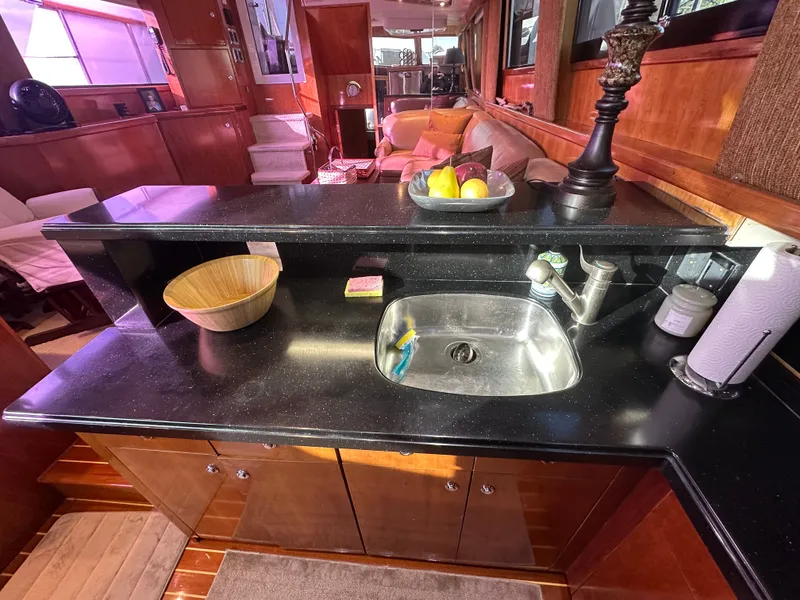 Slide: The Image of Luxurious kitchen interior of 1994 Hatteras 48 Cockpit MY yacht with sleek countertops. - 17