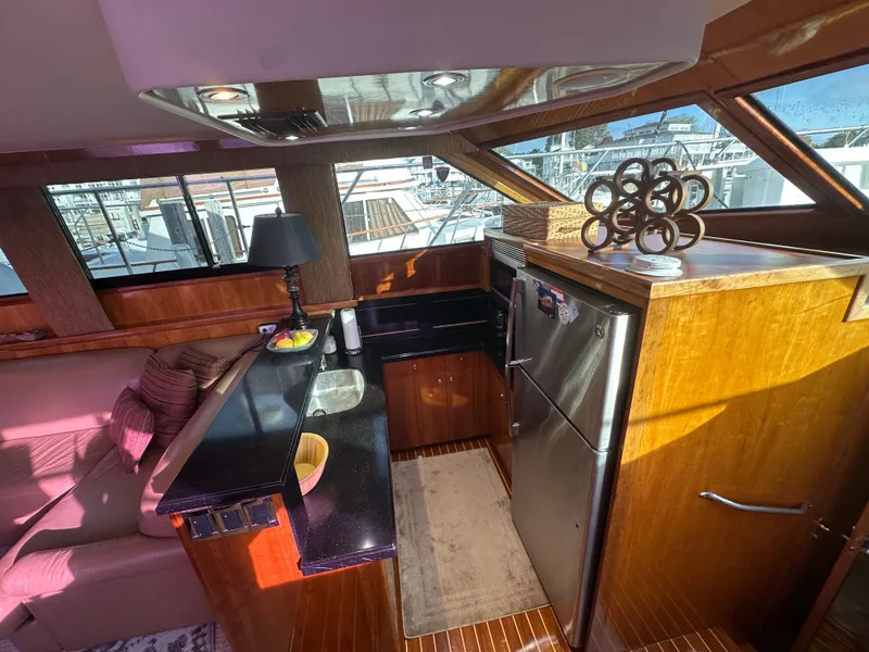 Slide: The Image of Interior of 1994 Hatteras 48 Cockpit MY yacht with modern kitchen and seating area. - 18