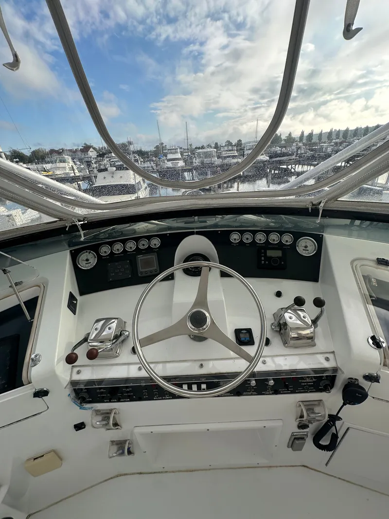 Slide: The Image of Cockpit view of 1994 Hatteras 48 Cockpit MY yacht with steering wheel and controls. - 2