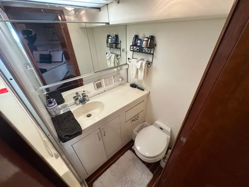 Slide: The Image of Bathroom interior of 1994 Hatteras 48 Cockpit MY yacht, featuring sink and toilet. - 24