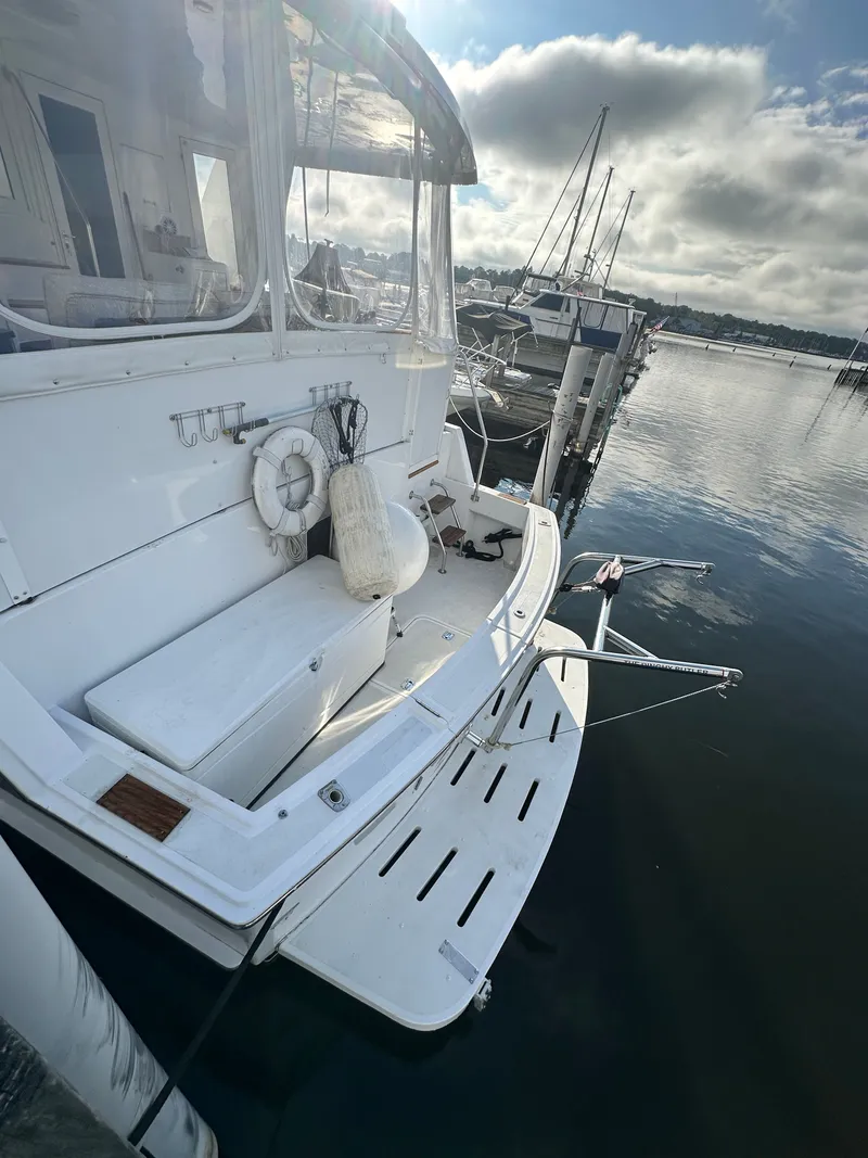 Slide: The Image of 1994 Hatteras 48 Cockpit MY yacht docked at marina, rear view. - 25
