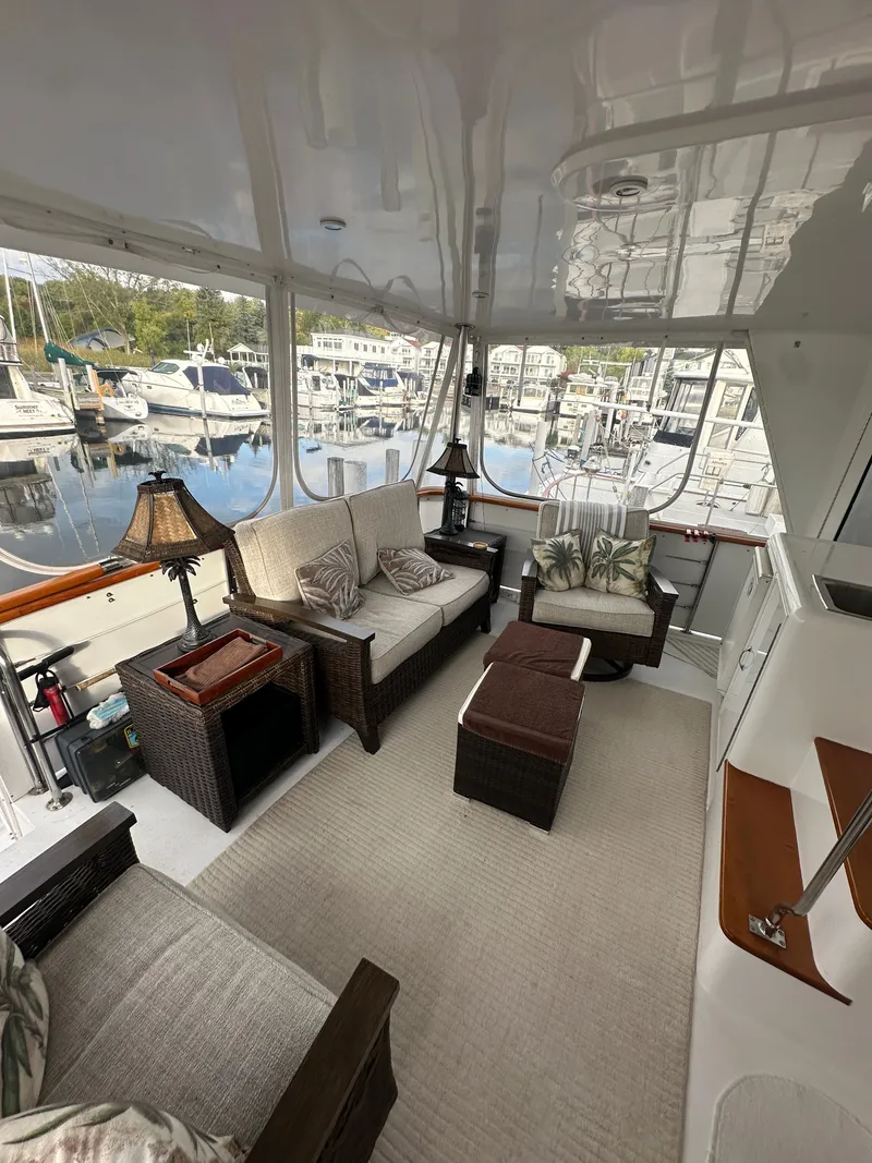 Slide: The Image of Luxurious interior of 1994 Hatteras 48 Cockpit MY yacht with elegant seating and decor. - 7