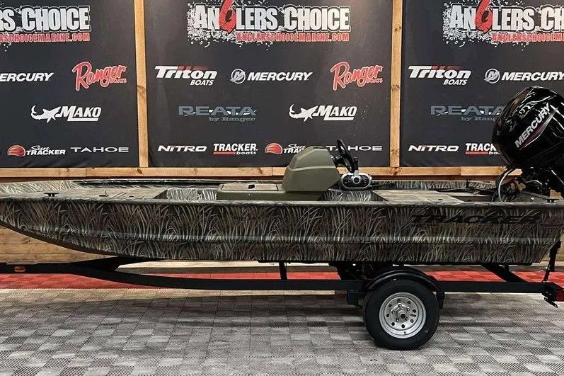 The Image of 2026 Tracker Grizzly 1648 SC boat on display with camouflage design and Mercury engine. - 1
