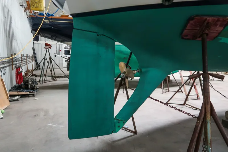 Slide: The Image of 1989 Morris Ocean Series 32 sailboat in dry dock, showing propeller and rudder. - 11