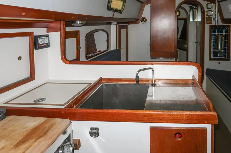 Slide: The Image of Interior of 1989 Morris Ocean Series 32 yacht, featuring a compact kitchen area. - 20