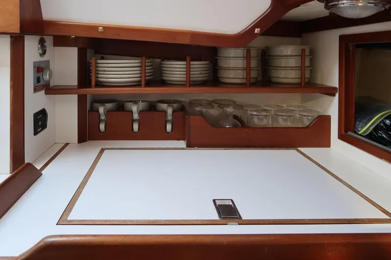 Slide: The Image of Galley kitchen in 1989 Morris Ocean Series 32 yacht with neatly arranged dishes and glasses. - 21