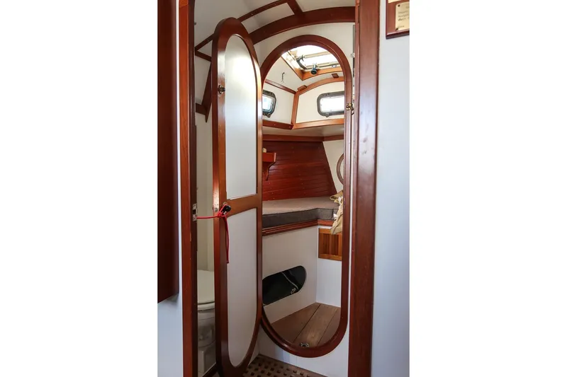 Slide: The Image of Interior of 1989 Morris Ocean Series 32 sailboat, featuring wooden trim and cozy cabin space. - 27