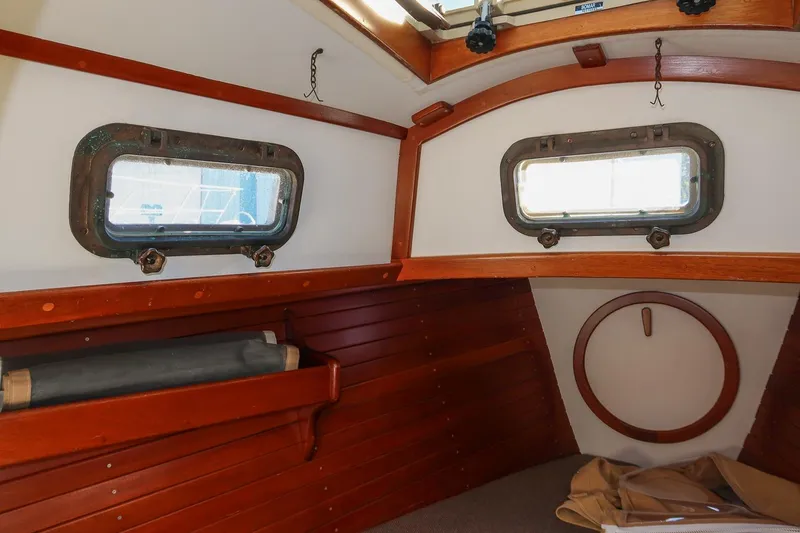 Slide: The Image of Interior of 1989 Morris Ocean Series 32 sailboat with wooden paneling and portholes. - 29