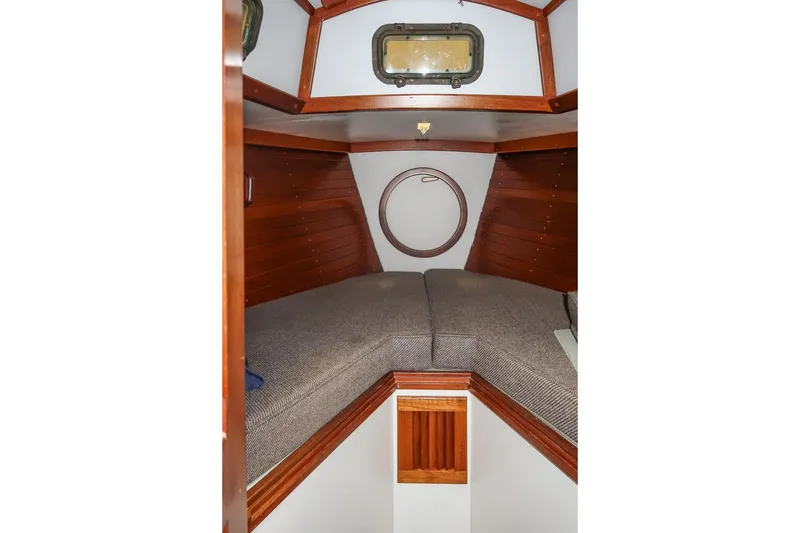 Slide: The Image of 1989 Morris Ocean Series 32 cabin interior with wooden paneling and cozy bedding. - 30