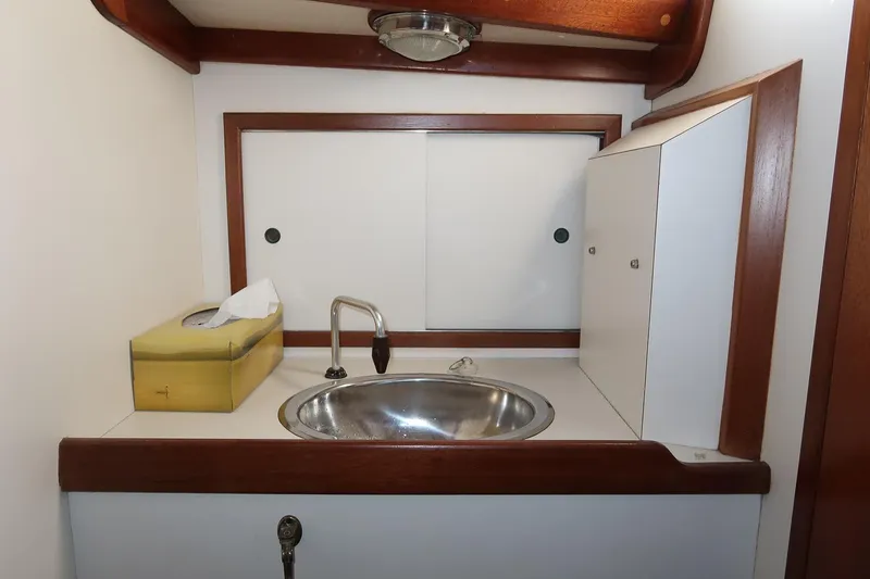 Slide: The Image of Compact sink area in 1989 Morris Ocean Series 32 yacht with wooden trim. - 33