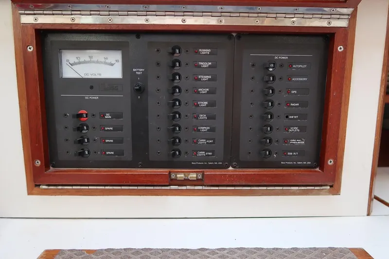 Slide: The Image of Control panel of a 1989 Morris Ocean Series 32 yacht with various switches and gauges. - 34