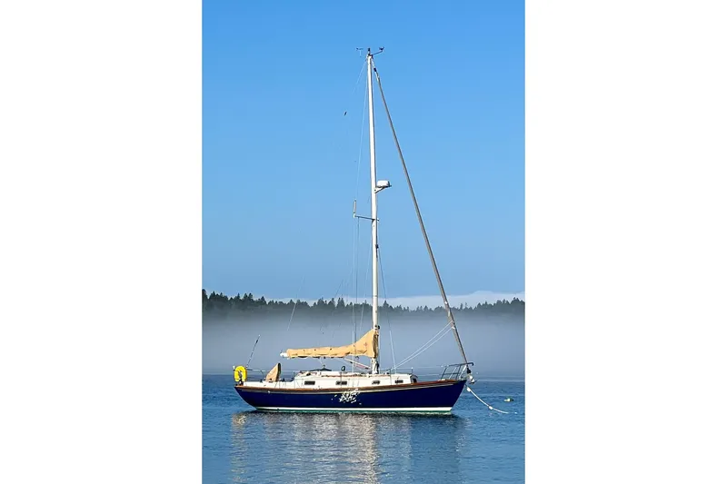 Slide: The Image of 1989 Morris Ocean Series 32 sailboat on calm water with misty forest background. - 5