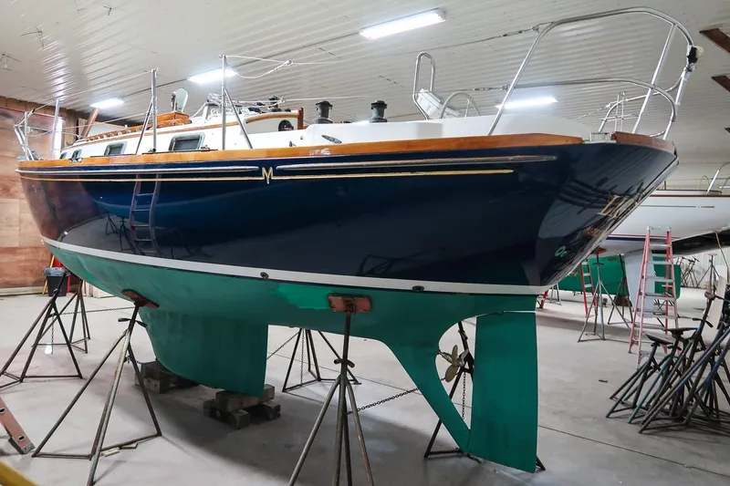 Slide: The Image of 1989 Morris Ocean Series 32 sailboat in indoor storage, elevated on stands. - 8