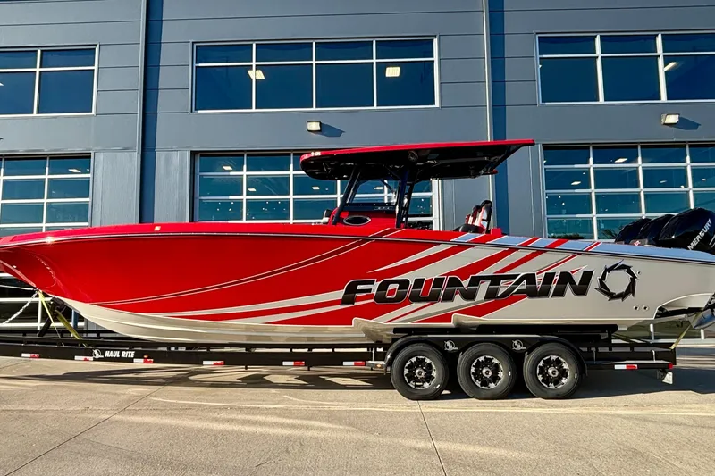 The Image of 2021 Fountain 38 SC boat with red and white design on a trailer. - 1