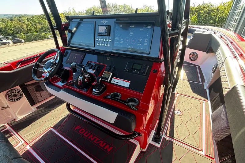 Slide: The Image of 2021 Fountain 38 SC boat cockpit with advanced controls and red interior design. - 22