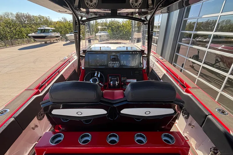 Slide: The Image of 2021 Fountain 38 SC boat cockpit with modern controls and red accents. - 27