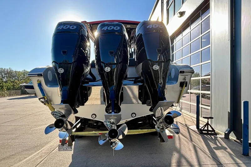 Slide: The Image of 2021 Fountain 38 SC boat with triple 400 horsepower engines, parked outdoors. - 3