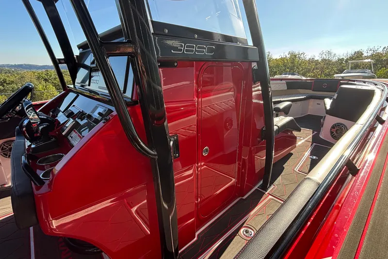 Slide: The Image of 2021 Fountain 38 SC boat interior with red console and seating area. - 31