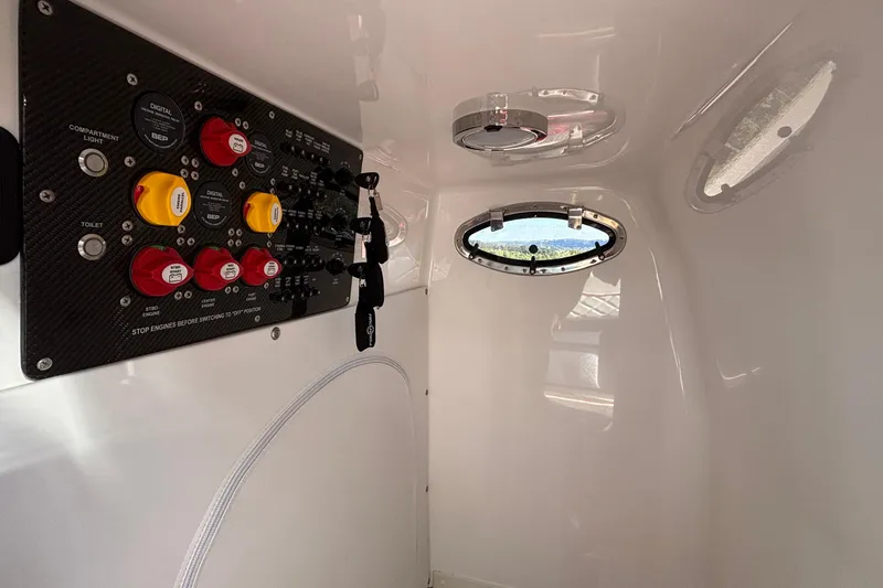 Slide: The Image of Control panel inside 2021 Fountain 38 SC boat cabin with porthole view. - 33