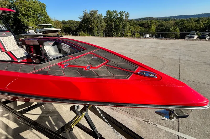 Slide: The Image of Red 2021 Fountain 38 SC boat on trailer, parked outdoors with scenic background. - 8