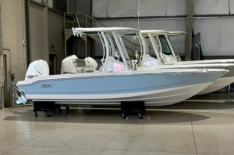 The Image of 2023 Boston Whaler 220 Dauntless boat in showroom, side view. - 0