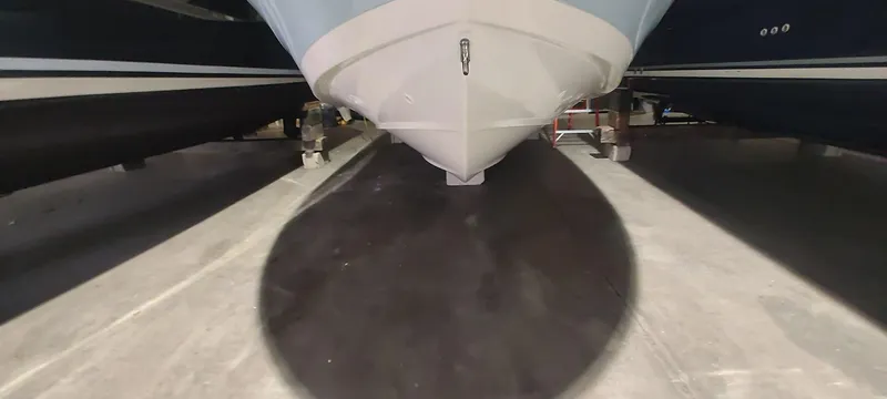 Slide: The Image of 2023 Boston Whaler 220 Dauntless boat hull in storage, viewed from below. - 10