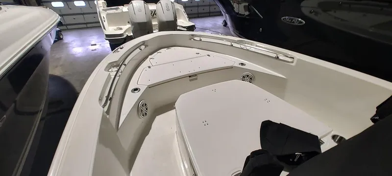 Slide: The Image of 2023 Boston Whaler 220 Dauntless boat interior, showcasing seating and storage areas. - 15