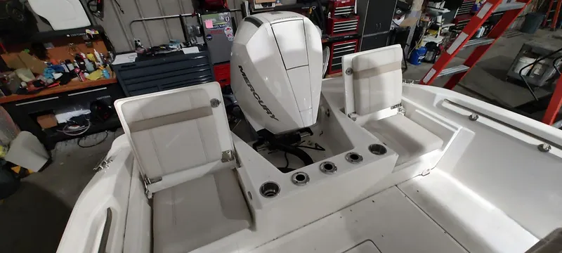 Slide: The Image of 2023 Boston Whaler 220 Dauntless boat interior with Mercury outboard engine. - 18