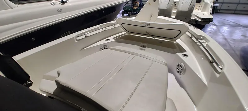 Slide: The Image of 2023 Boston Whaler 220 Dauntless boat interior with cushioned seating and sleek design. - 21