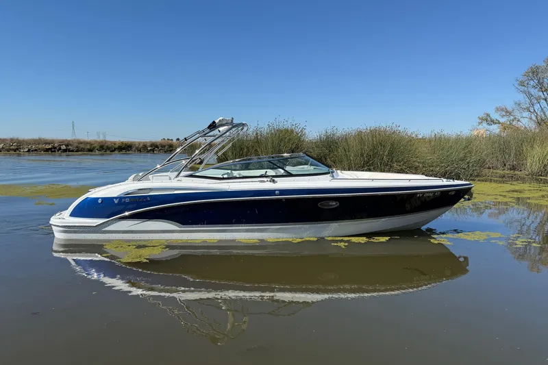 The Image of 2008 Formula 310 Bowrider boat on calm water with clear blue sky. - 0
