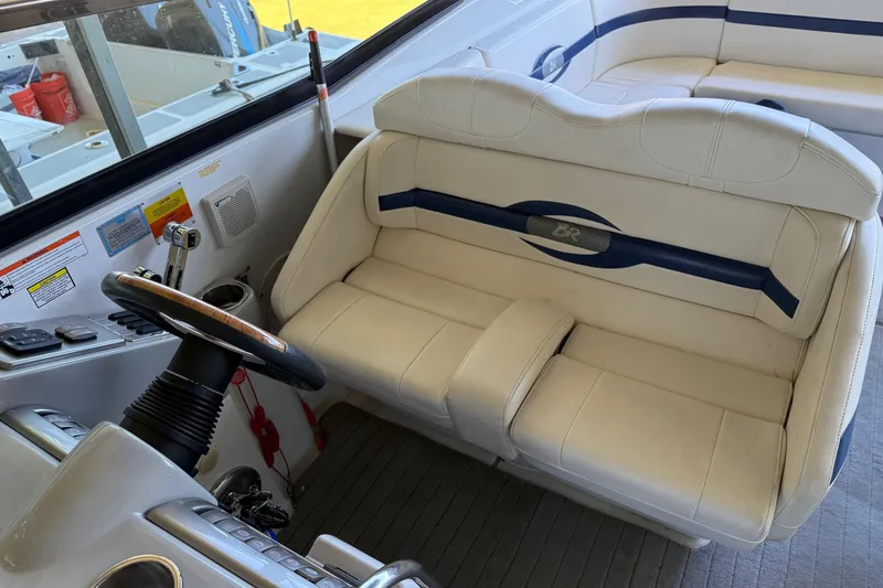 Slide: The Image of 2008 Formula 310 Bowrider cockpit with white leather seating and steering wheel. - 11