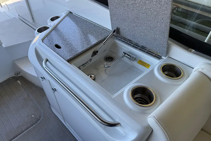 Slide: The Image of 2008 Formula 310 Bowrider boat sink and cup holders in cockpit area. - 17