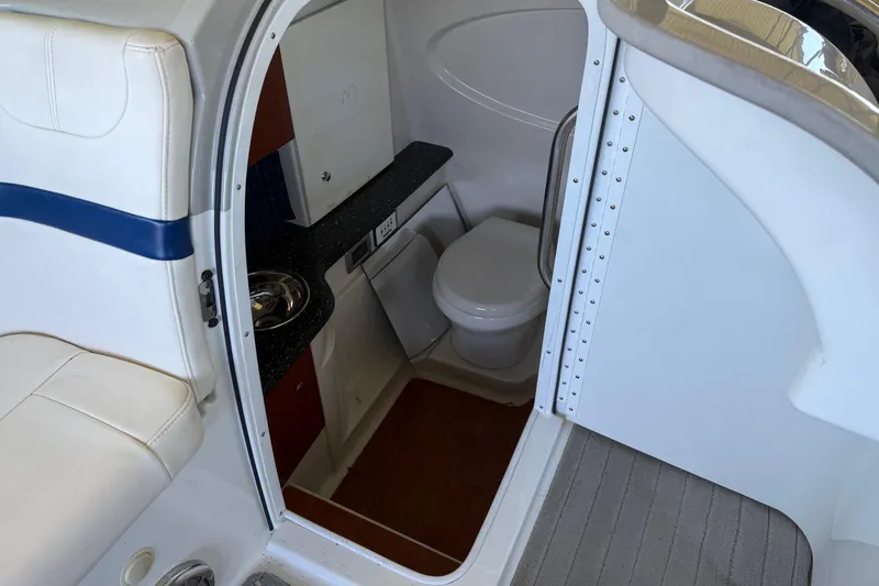 Slide: The Image of 2008 Formula 310 Bowrider interior with compact bathroom and seating area. - 18