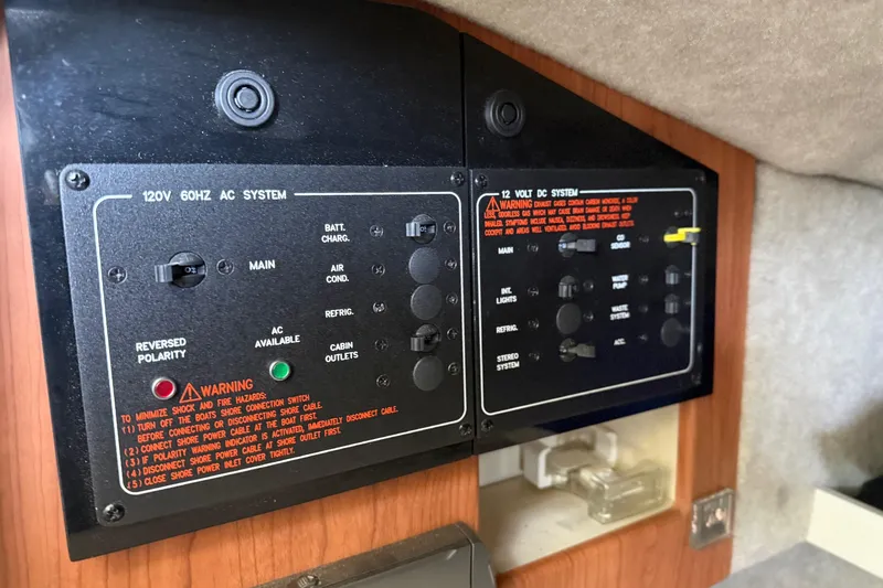 Slide: The Image of Control panel of a 2008 Formula 310 Bowrider boat, featuring AC and DC systems. - 22