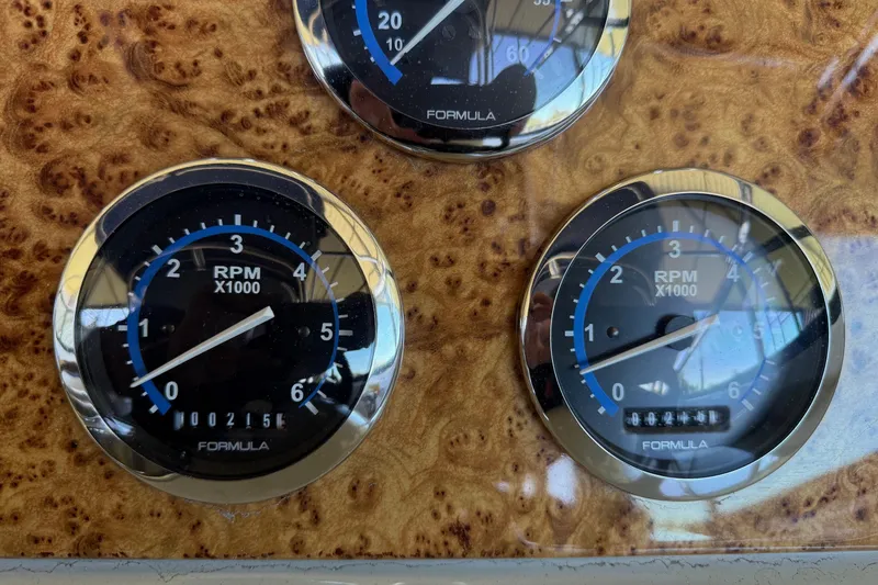 Slide: The Image of Close-up of 2008 Formula 310 Bowrider RPM gauges on a wood-patterned dashboard. - 26