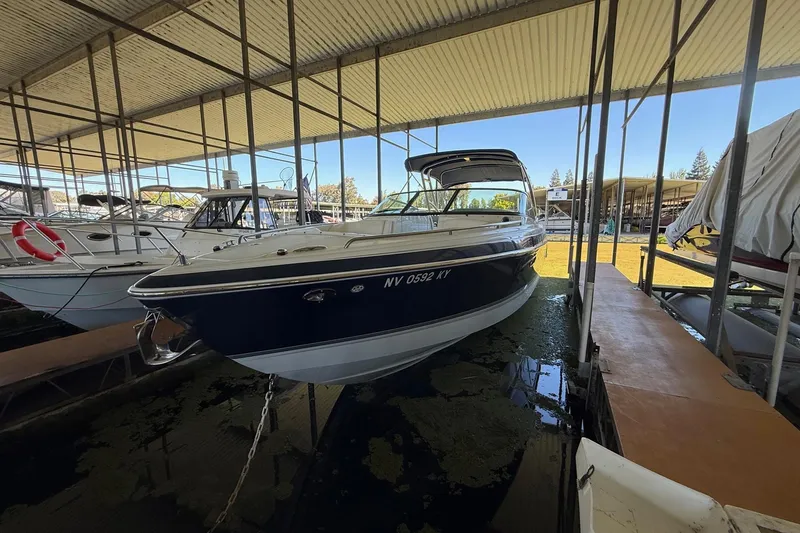 Slide: The Image of 2008 Formula 310 Bowrider docked in a covered marina, side view. - 29