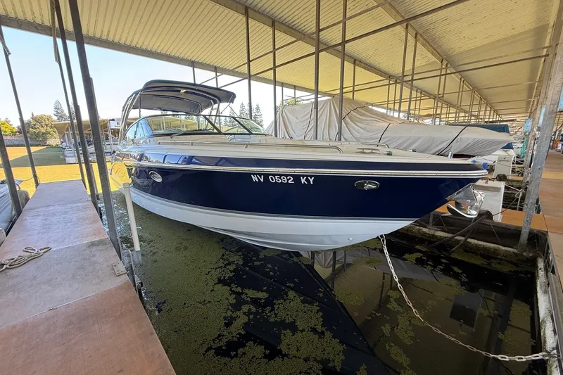 Slide: The Image of 2008 Formula 310 Bowrider boat docked in covered marina. - 30