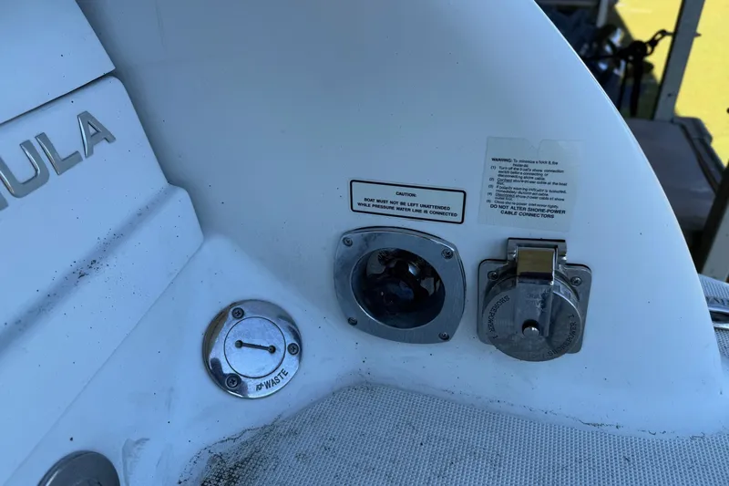 Slide: The Image of 2008 Formula 310 Bowrider boat utility panel with waste and shore power connectors. - 35