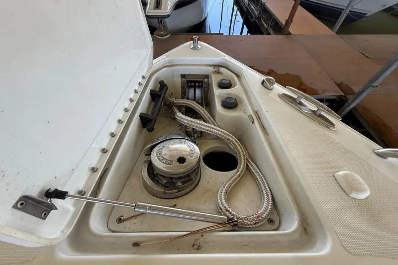 Slide: The Image of 2008 Formula 310 Bowrider anchor compartment with winch and rope. - 36