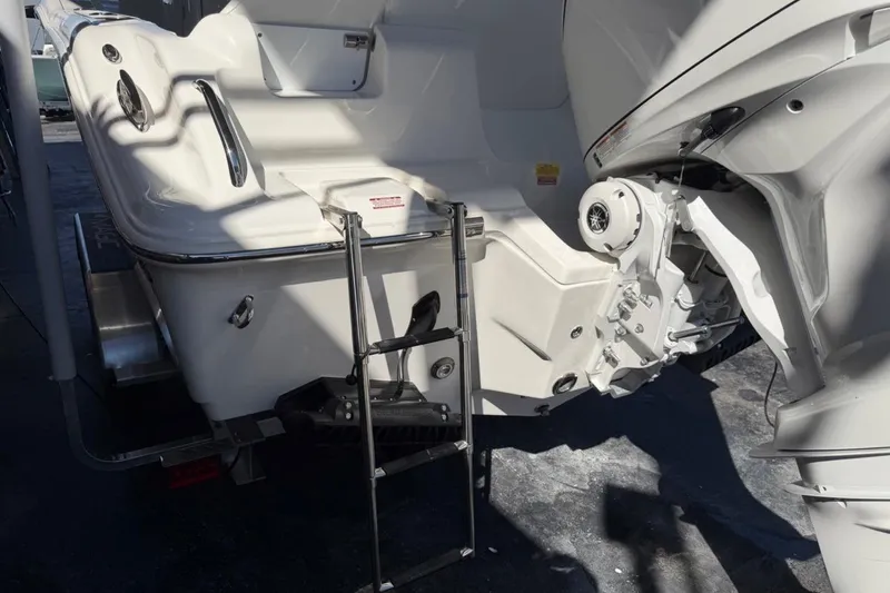 Slide: The Image of 2026 Key West 239 FSR boat stern with ladder and engine detail. - 10