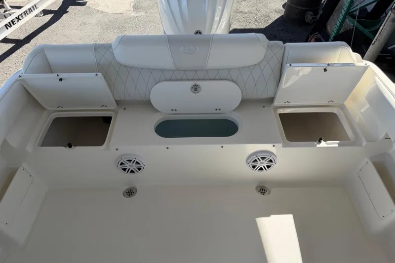 Slide: The Image of 2026 Key West 239 FSR boat interior with storage compartments and speakers. - 16