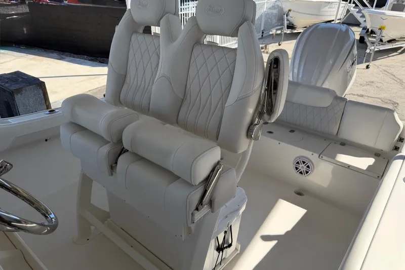 Slide: The Image of 2026 Key West 239 FSR boat interior with luxurious white seating and steering wheel. - 17