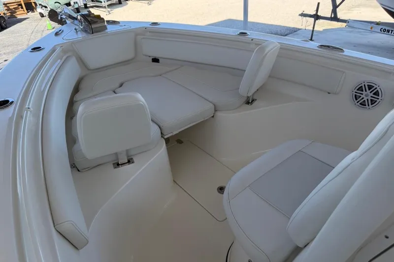 Slide: The Image of 2026 Key West 239 FSR boat interior with white seating and speaker. - 19