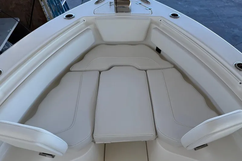 Slide: The Image of 2026 Key West 239 FSR boat interior with cushioned seating and cup holders. - 20
