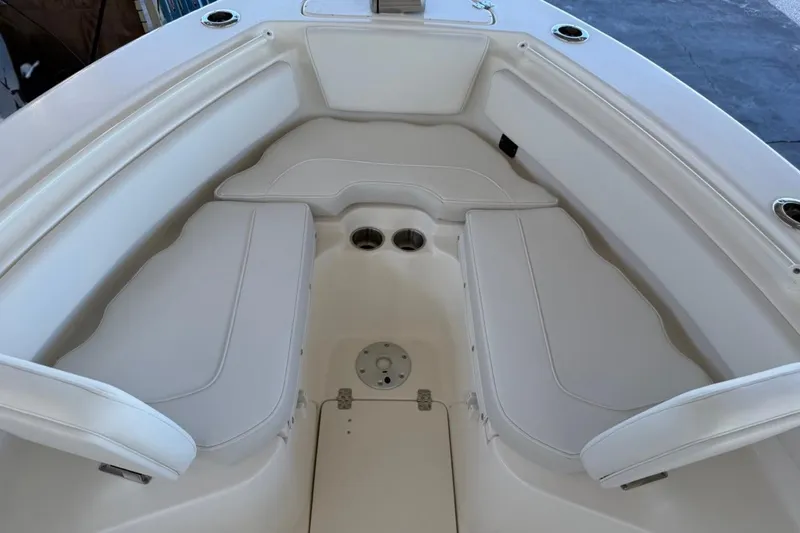 Slide: The Image of 2026 Key West 239 FSR boat interior with white cushioned seating. - 22