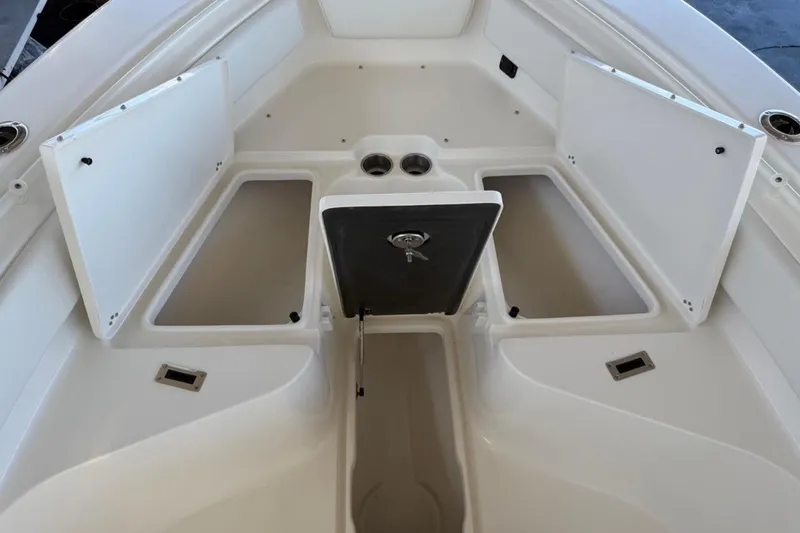 Slide: The Image of 2026 Key West 239 FSR boat storage compartments open, showcasing spacious interior design. - 24