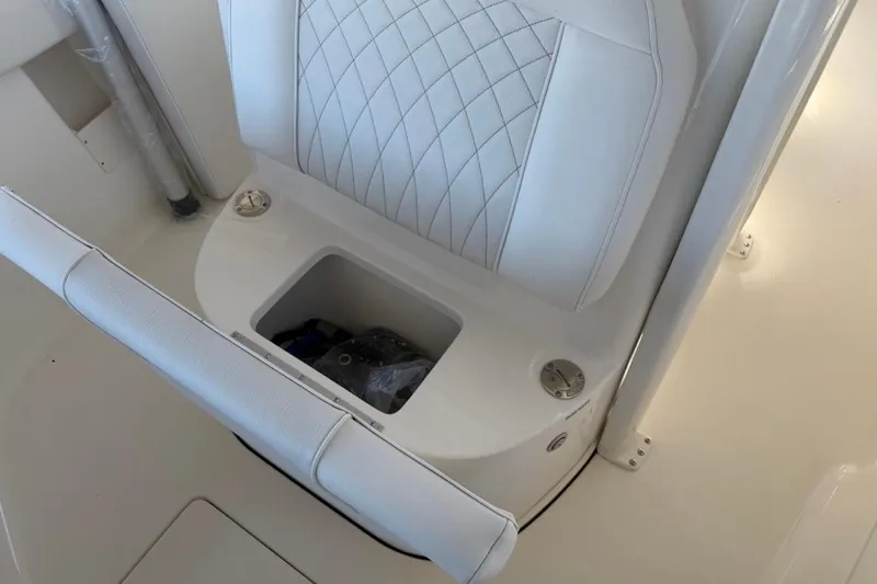 Slide: The Image of 2026 Key West 239 FSR boat seat with storage compartment open. - 26