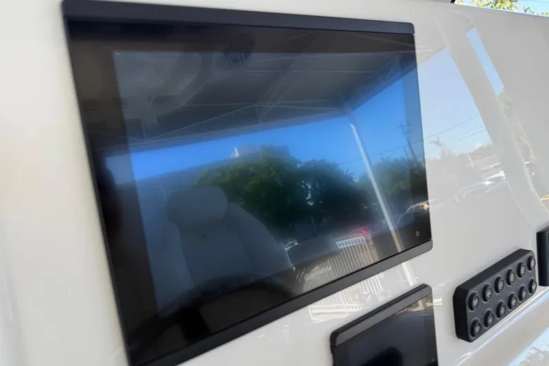 Slide: The Image of 2026 Key West 239 FSR boat dashboard with touchscreen display and control panel. - 28