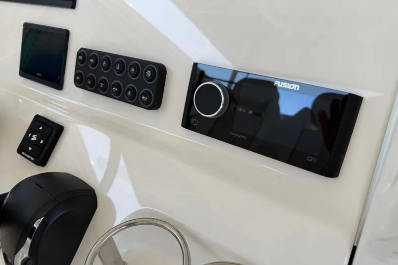 Slide: The Image of 2026 Key West 239 FSR boat dashboard with Fusion stereo and control panel. - 29