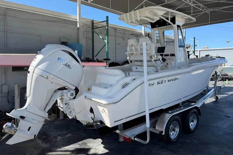 Slide: The Image of 2026 Key West 239 FSR boat with Yamaha engine on trailer, parked under shelter. - 3